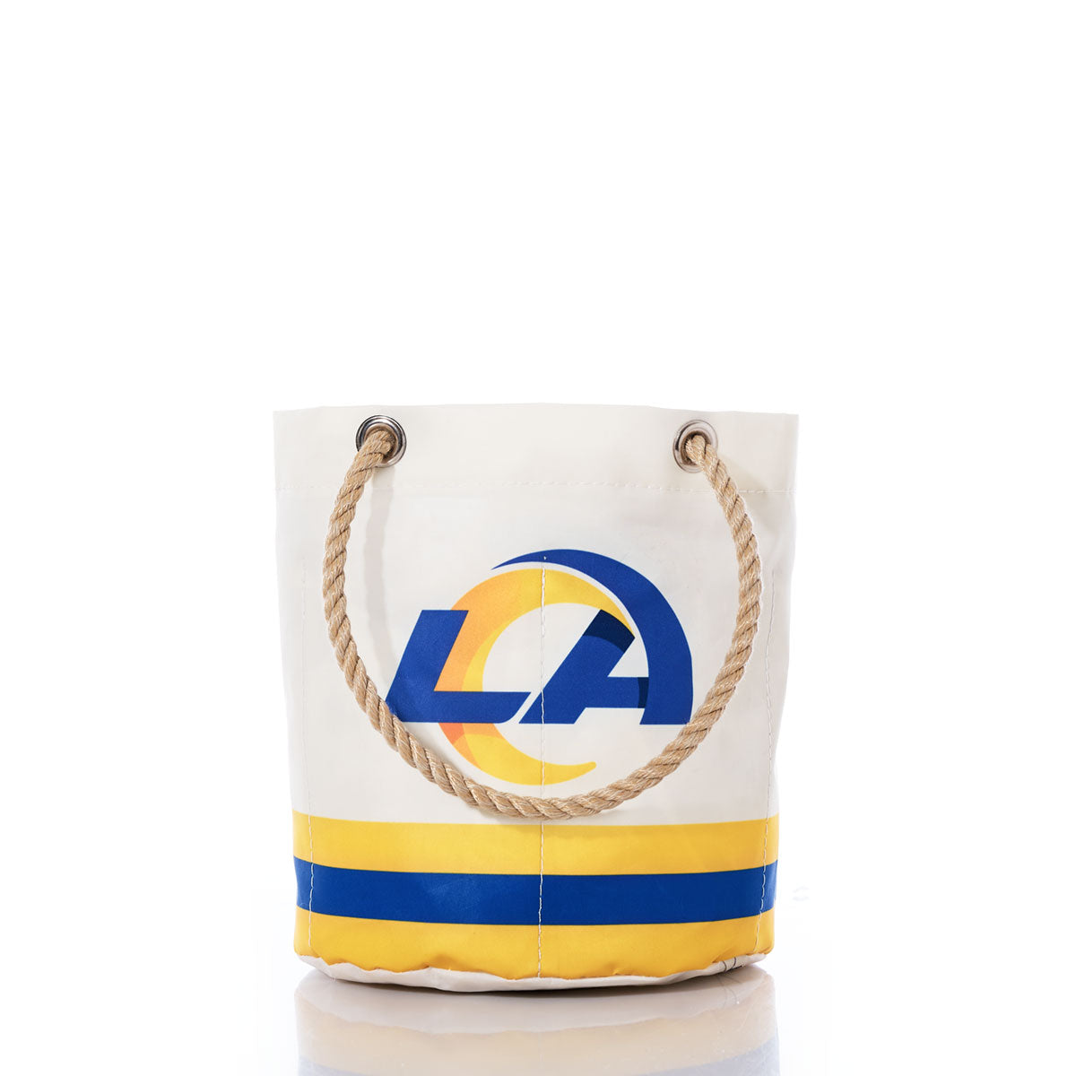 Introducing the Los Angeles Rams Beverage Bucket by Sea Bags—a white sail cloth bag with sturdy rope handles, showcasing a bold blue and yellow Rams logo on the front along with two matching horizontal stripes near the base. Crafted from durable sail cloth, this versatile bag serves as both a sustainable cooler and a stylish beverage bucket, perfect for any occasion. by Sea Bags