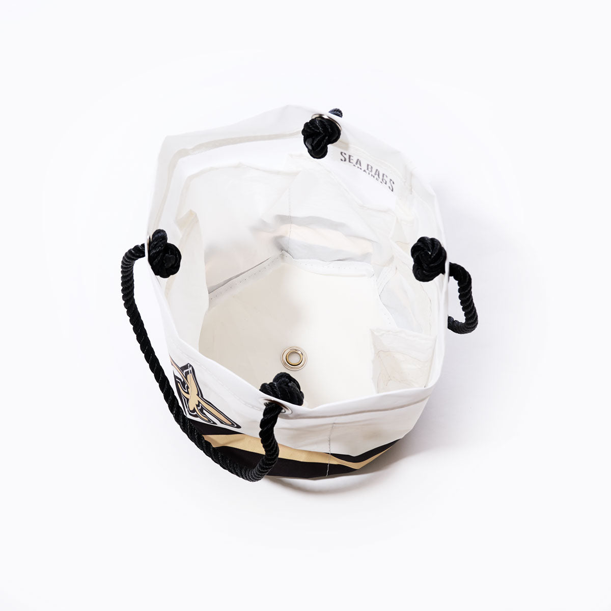The New Orleans Saints Beverage Bucket by Sea Bags features an open-top white canvas design with black rope handles, a metal grommet at the base, and a signature patch on the side—offering a stylish and functional option that serves as both a sustainable cooler and beverage bucket. Pictured on a plain white background. by Sea Bags