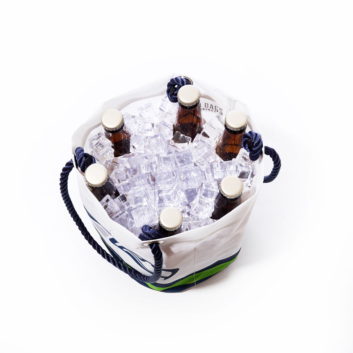 The Sea Bags Seattle Seahawks Beverage Bucket—a white container with blue rope handles crafted from recycled sail cloth—holds six brown bottles and ice cubes, seen from above against a white background. by Sea Bags