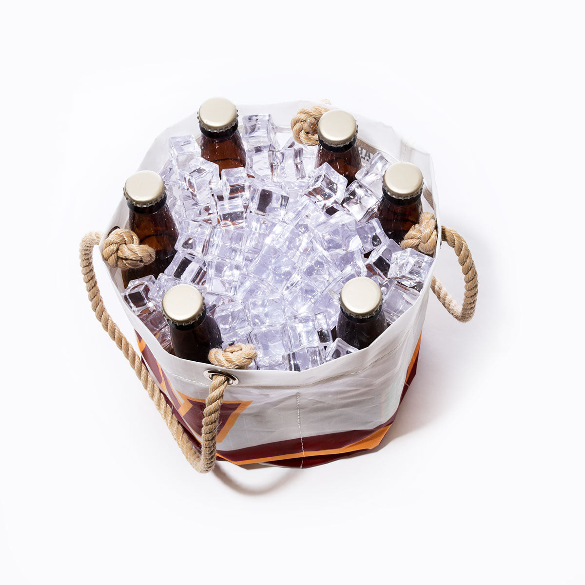 Six brown glass bottles are placed upright in a round, sustainable Sea Bags Washington Commanders Beverage Bucket filled with ice cubes, featuring rope handles on each side and an NFL logo bag design, against a white background. by Sea Bags