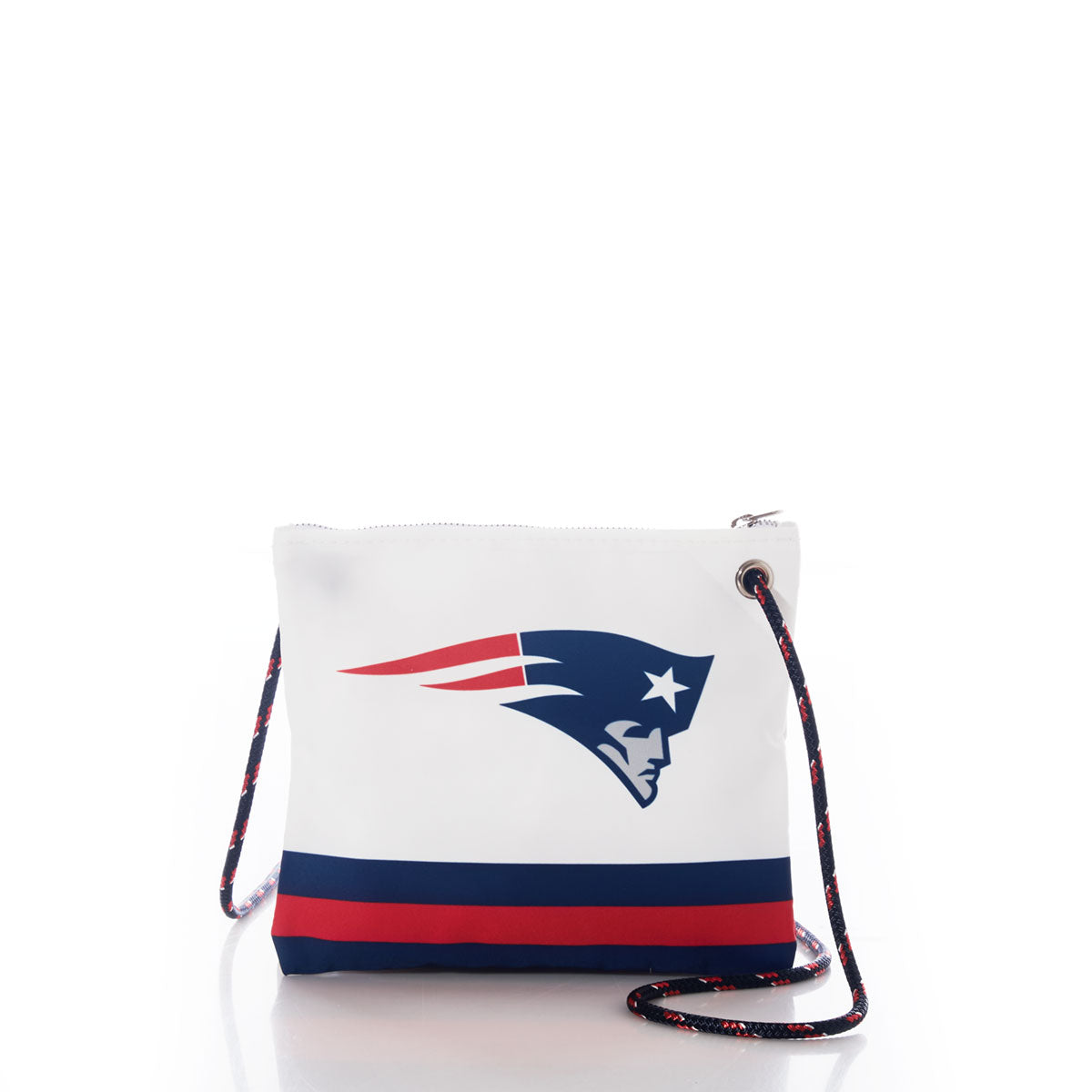 Sea Bags New England Patriots Slim Crossbody crafted from white recycled sail cloth, featuring the Patriots logo, a blue and red stripe along the bottom, and a navy and red rope strap. This sustainable crossbody showcases team spirit with an eco-friendly design. by Sea Bags