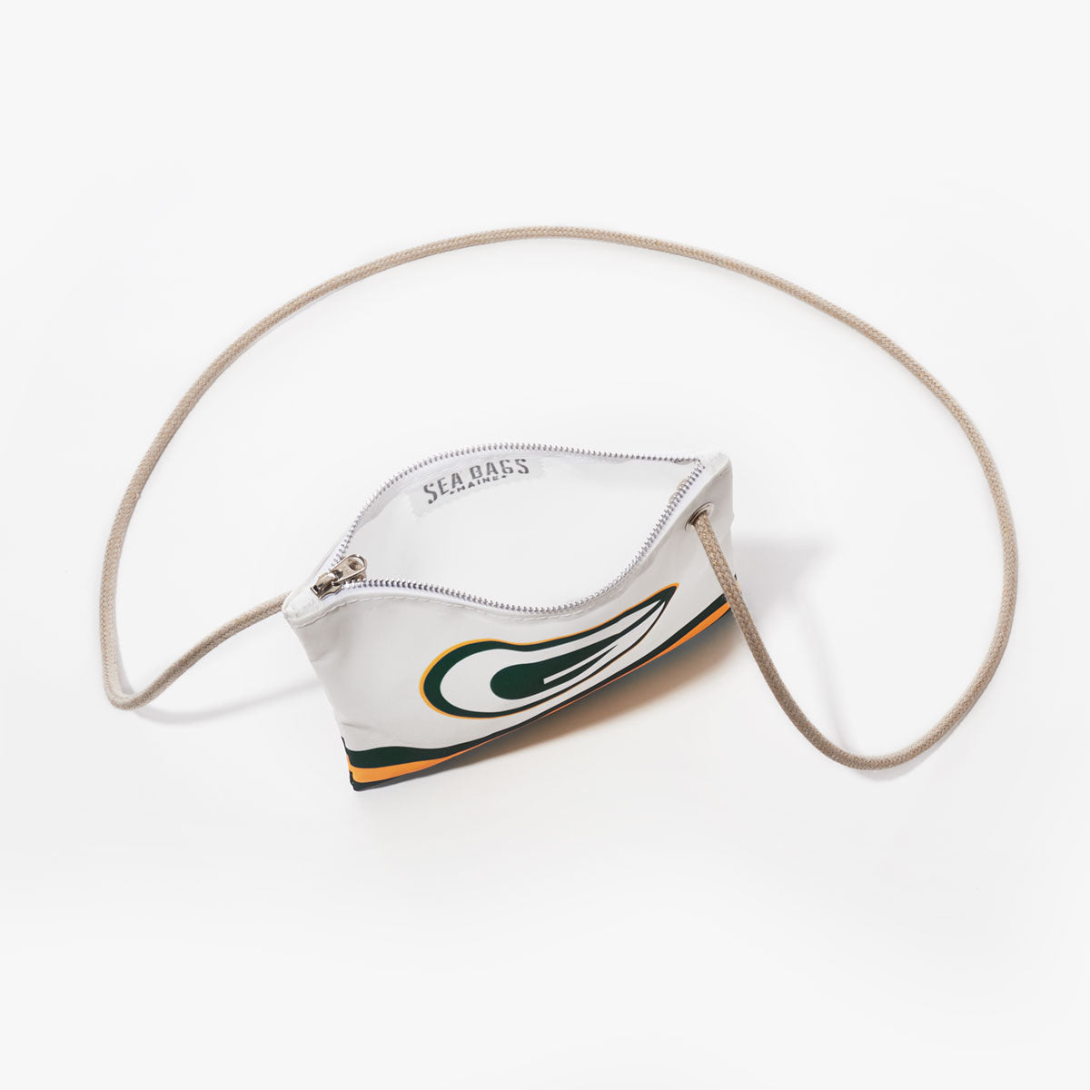 The Sea Bags Green Bay Packers Slim Crossbody is a small white zippered pouch, featuring a beige cord strap and made from recycled sail cloth. The bag showcases a stylized green and yellow Green Bay Packers logo design and is photographed on a white background. by Sea Bags