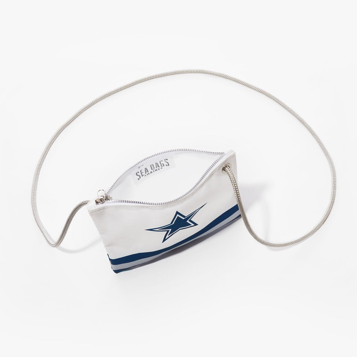Sea Bags Dallas Cowboys Slim Crossbody, made from recycled sail cloth and displayed on a white background, features a white zippered design adorned with a blue star logo inspired by the Dallas Cowboys, blue stripes near the base, and a thin shoulder strap. by Sea Bags