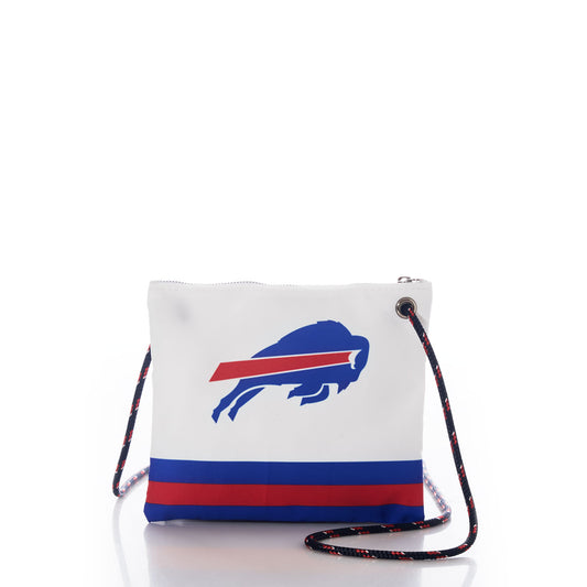 The Buffalo Bills Slim Crossbody by Sea Bags features blue and red stripes and a bold blue Buffalo Bills logo on white recycled sail cloth for a sustainable style statement. Designed with a black rope strap, this eco-friendly crossbody bag is showcased against a white background. by Sea Bags