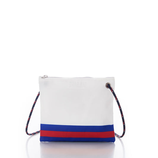 Buffalo Bills Slim Crossbody by Sea Bags, a handcrafted white crossbody bag made from recycled sail cloth, features a navy and red striped bottom and a multicolored rope strap. Shown on a white background, this sustainable accessory combines style with eco-conscious design. by Sea Bags