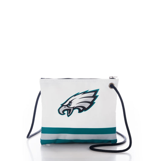 Introducing the Sea Bags Philadelphia Eagles Slim Crossbody—a sustainable gift for Philly fans, crafted from recycled sail cloth. This white crossbody bag features the iconic Eagles logo, teal and gray stripes along the bottom, and a black shoulder strap, all showcased against a white background. by Sea Bags