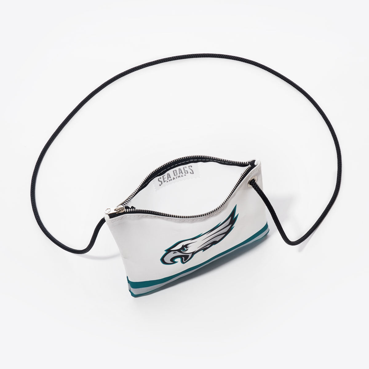 Introducing the Philadelphia Eagles Slim Crossbody by Sea Bags—a compact white bag crafted from recycled sail cloth, featuring a bold green and black Eagles logo, a visible zipper opening, and a sturdy black strap. This stylish and sustainable accessory is the perfect gift for any Philadelphia fan on any occasion. by Sea Bags