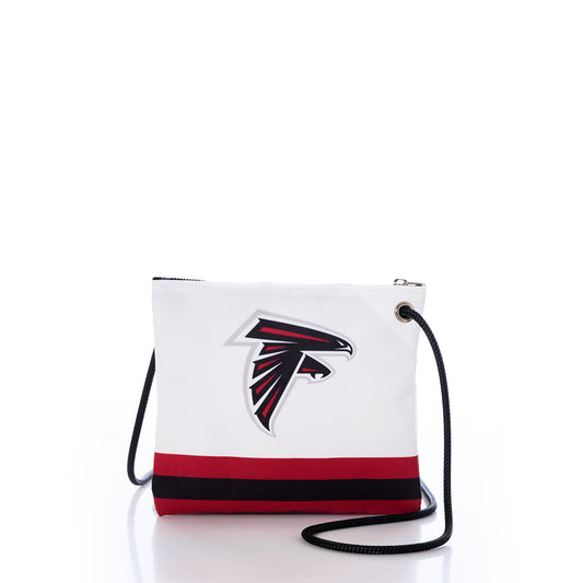 The Atlanta Falcons Slim Crossbody by Sea Bags is a white bag crafted from durable recycled sail cloth, featuring the teams logo, black and red stripe accents, a black strap, and a zippered top. Displayed against a white background, this crossbody is perfect for every dedicated Atlanta Falcons fan. by Sea Bags