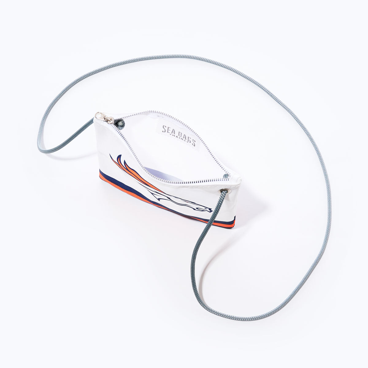 The Denver Broncos Slim Crossbody by Sea Bags is crafted from recycled sail cloth and showcases the team logo on a white background, making it the ideal NFL logo bag for dedicated fans. by Sea Bags