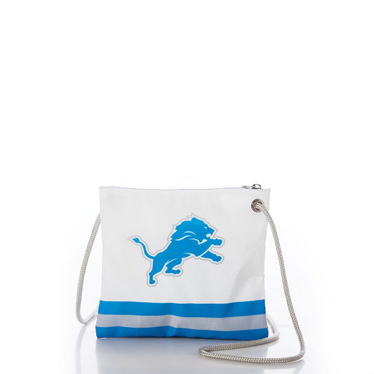 Show your Lions pride with the Detroit Lions Slim Crossbody by Sea Bags, crafted from recycled sail cloth for an eco-friendly touch. This white crossbody features a silver strap, bold blue Detroit Lions logo, and two horizontal blue stripes at the bottom—making it a stylish and sustainable accessory for any fan. by Sea Bags