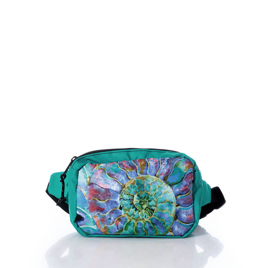The Sea Bags Multicolor Nautilus Belt Bag features a vibrant nautilus shell design on teal, made from recycled sail cloth. Displayed against a white background with its reflection below, this bag includes an adjustable waistband for a comfortable and secure fit throughout the day. by Sea Bags