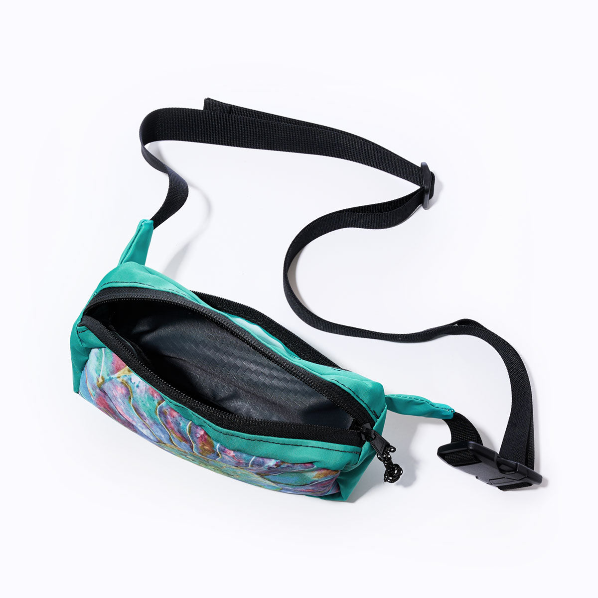 The Multicolor Nautilus Belt Bag by Sea Bags features a black adjustable waistband, an open main compartment, and a vibrant abstract pattern on the front—thoughtfully crafted from recycled sail cloth for a distinctive and eco-friendly style. by Sea Bags