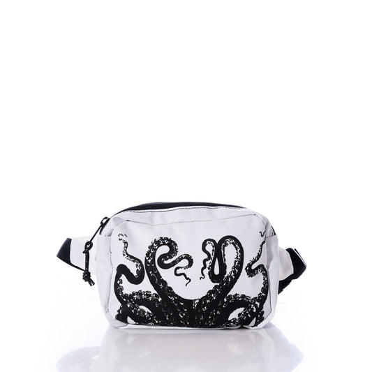 The Sea Bags Octopus Belt Bag, crafted from recycled sail cloth, features a bold black octopus tentacle design on the front and is pictured against a white background with a subtle reflection—a stylish and eco-friendly upgrade to your travel essentials. by Sea Bags