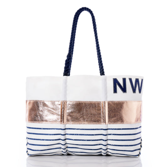 Introducing the Sea Bags Custom Monogram Rose Gold-on-Navy Mariner Stripe Large Tote—a personalized carryall featuring navy rope handles, a striking metallic rose gold accent, and your custom monogram in navy on the upper right, creating a chic nautical statement. by Sea Bags