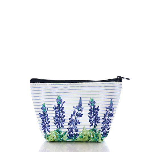 The Lupine Sailor Stripe Cosmetic Bag by Sea Bags features a white zippered design with blue horizontal stripes and a pattern of purple lupine flowers and green leaves along the bottom edge, crafted from washable sailcloth for coastal charm, photographed on a white background. by Sea Bags