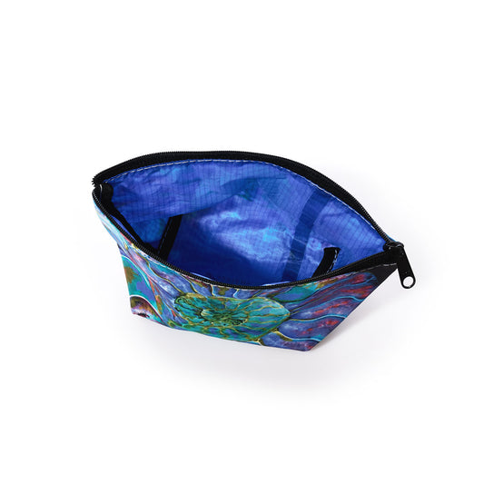 The Sea Bags Multicolor Nautilus Cosmetic Bag features a zippered pouch with a blue and multicolored watercolor nautilus shell design on the exterior and a plain blue interior, displayed against a white background. Made from recycled sail cloth, this bag offers both durability and eco-friendly style. by Sea Bags