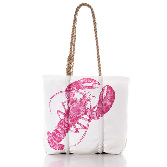 The Sea Bags Pink Lobster Medium Tote is a white tote bag with tan rope handles, featuring a large pink lobster illustrated in a watercolor style by a Maine artist on the front, set against a plain white background. by Sea Bags