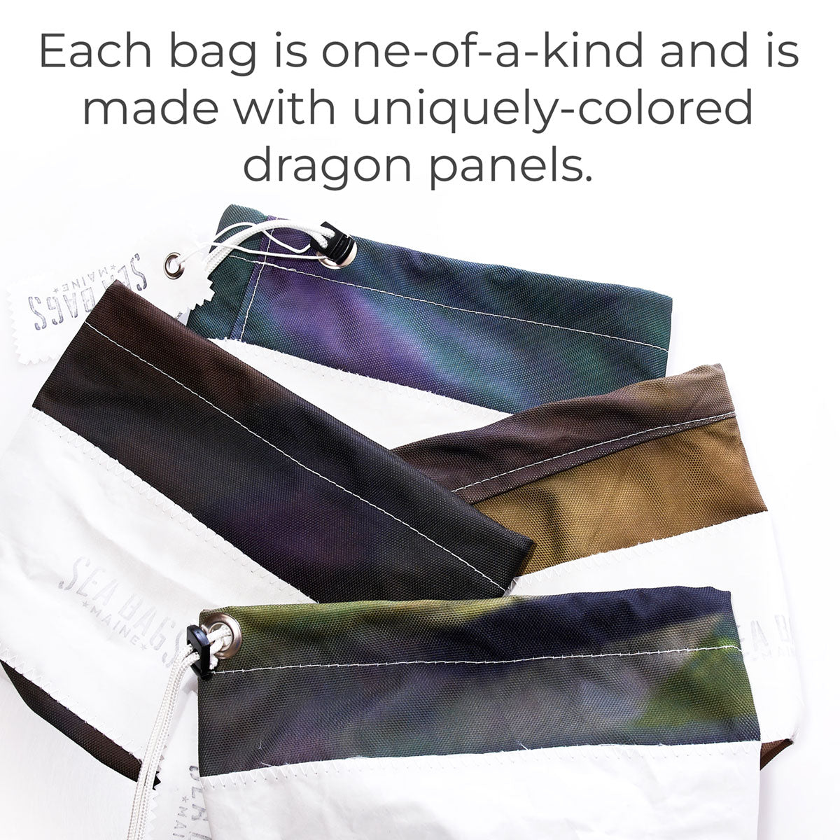 Three zippered Dragon Skin Ditty Bags by Sea Bags are shown, each featuring white sections paired with distinctively colored dragon panels. Text above highlights that every bag is a sustainable, one-of-a-kind creation—standing out just like the Empire State Building against the skyline. by Sea Bags