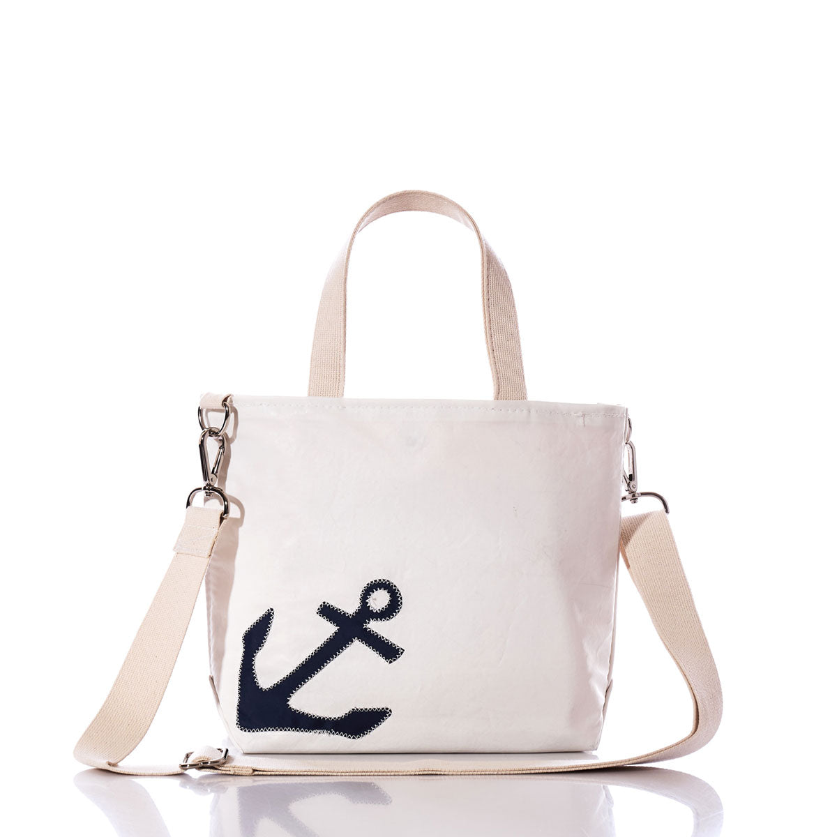 Introducing the Navy Anchor Crossbody Tote by Sea Bags—a white canvas tote crafted from recycled sailcloth, featuring beige handles and strap, and a striking navy blue anchor graphic on the front. This eco-friendly bag blends nautical style with sustainable design. by Sea Bags