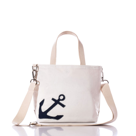 Introducing the Navy Anchor Crossbody Tote by Sea Bags—a white canvas tote crafted from recycled sailcloth, featuring beige handles and strap, and a striking navy blue anchor graphic on the front. This eco-friendly bag blends nautical style with sustainable design. by Sea Bags