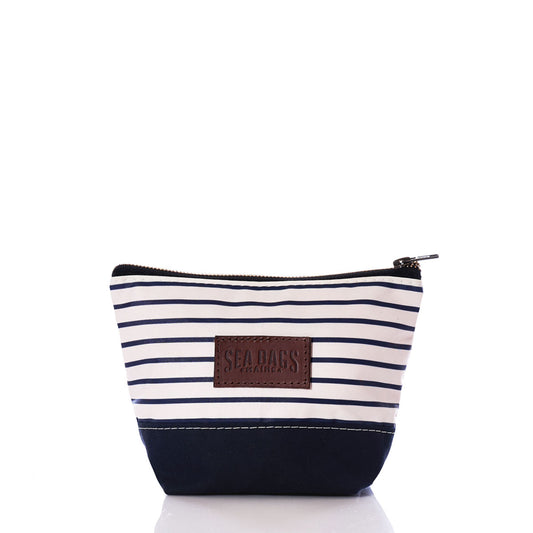 Introducing the Navy Mariner Stripe Chebeague Cosmetic Bag by Sea Bags—a small zippered cosmetic bag featuring navy and white horizontal stripes, a solid navy bottom crafted from durable recycled sailcloth, and a brown leather Sea Bags patch on the front. by Sea Bags