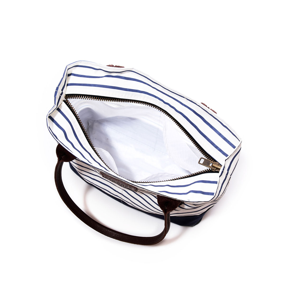 Top view of an open Sea Bags Navy Mariner Stripe Chebeague Handbag, handmade from recycled sail cloth with dark handles and a zippered closure, revealing an empty white-lined interior against a white background. by Sea Bags