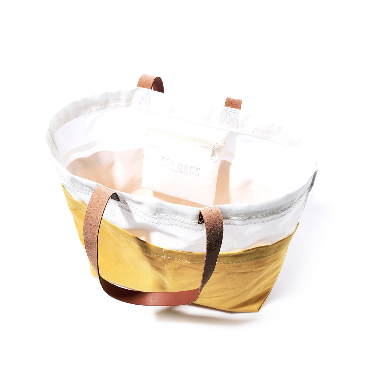 The Golden Yellow Chebeague Market Tote by Sea Bags is a two-tone bag crafted from yellow and white fabric with durable leather handles, shown empty against a white background. by Sea Bags