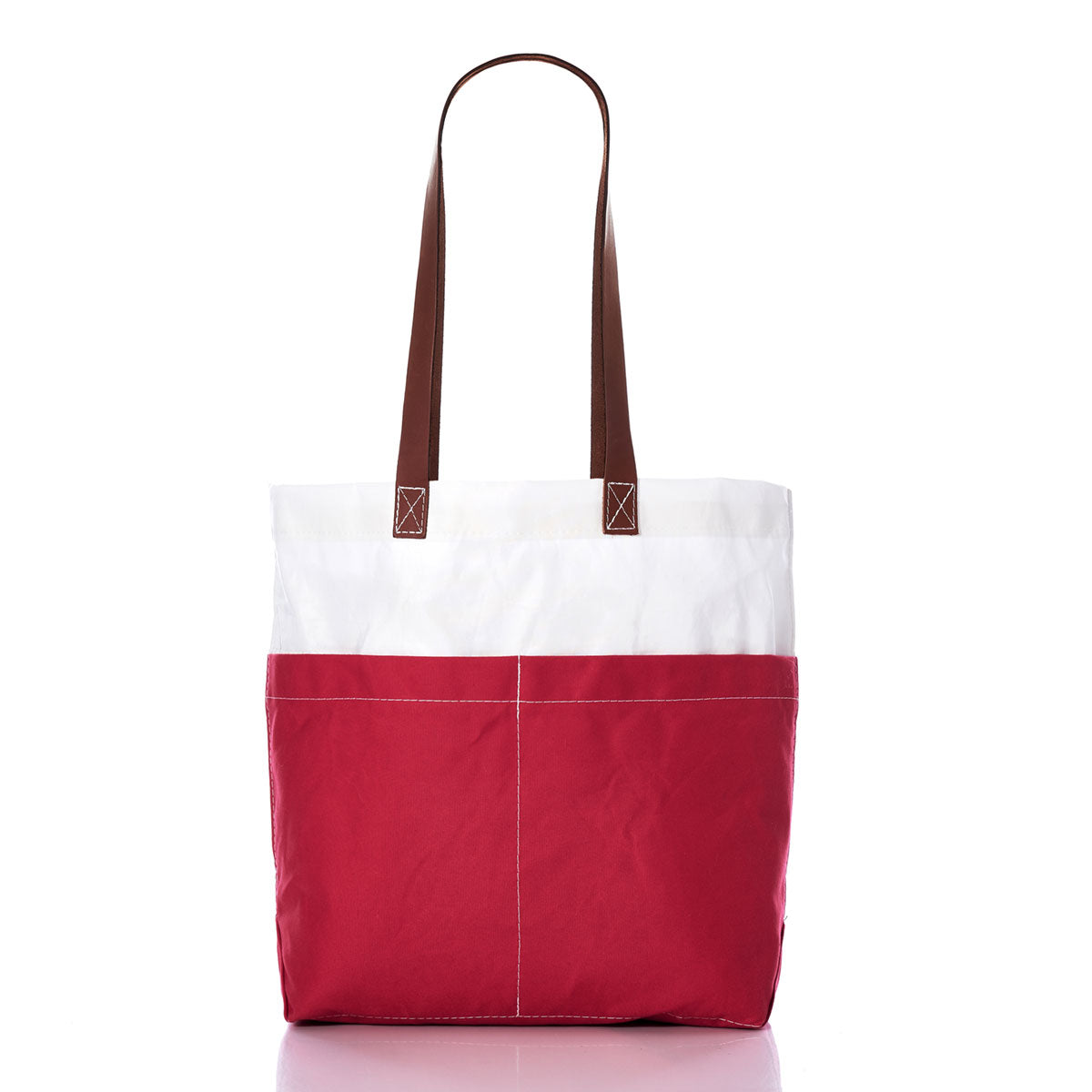 The Red Chebeague Market Tote by Sea Bags is crafted from recycled sails and features a white upper section, a vibrant red lower section, and sturdy leather handles with visible exterior stitching. Stylish and sustainable, this tote is displayed against a white background. by Sea Bags