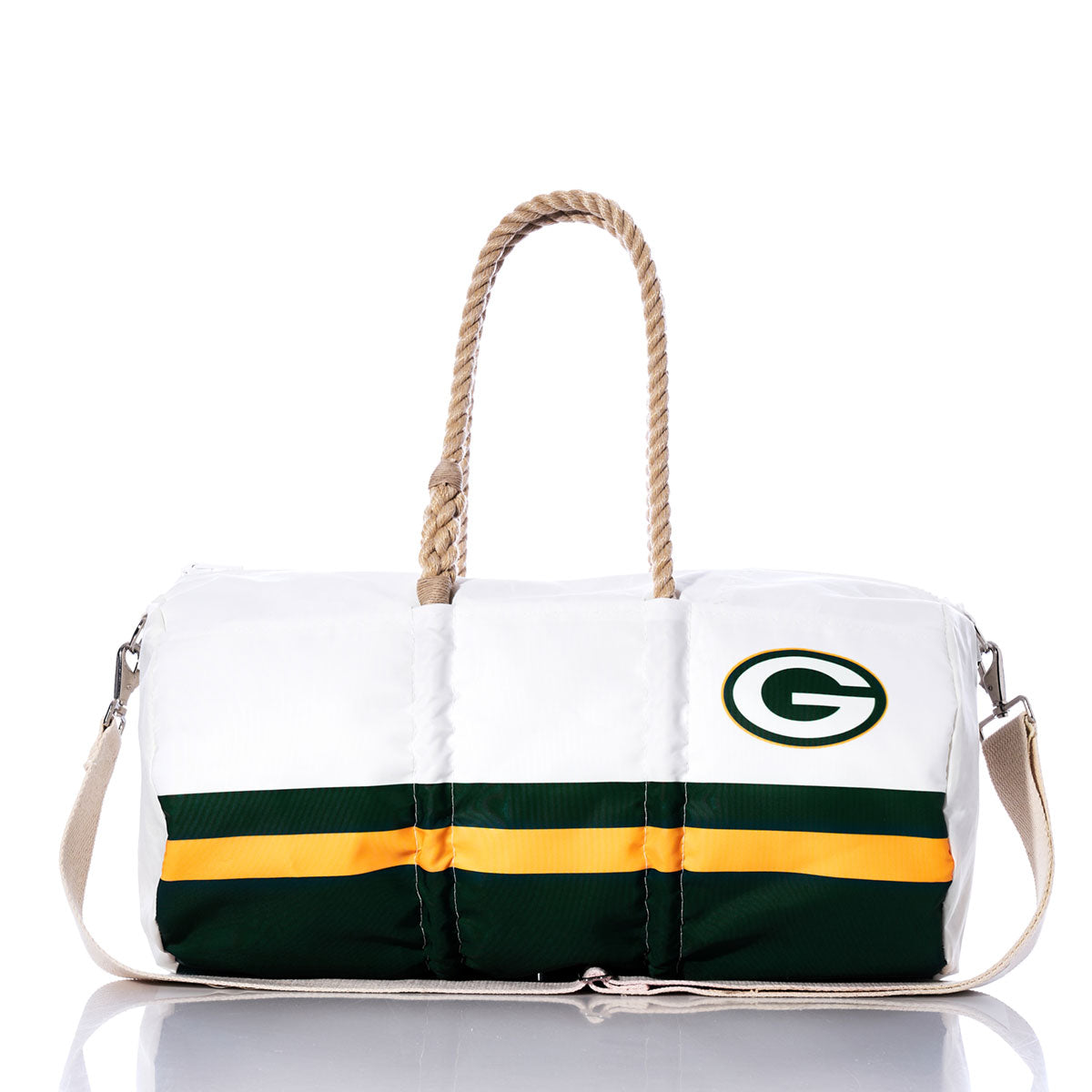 The Green Bay Packers Duffel by Sea Bags is crafted from recycled sail cloth, features tan rope handles, bold green and yellow stripes, and a prominent Green Bay logo on the side; it is displayed on a reflective surface. by Sea Bags