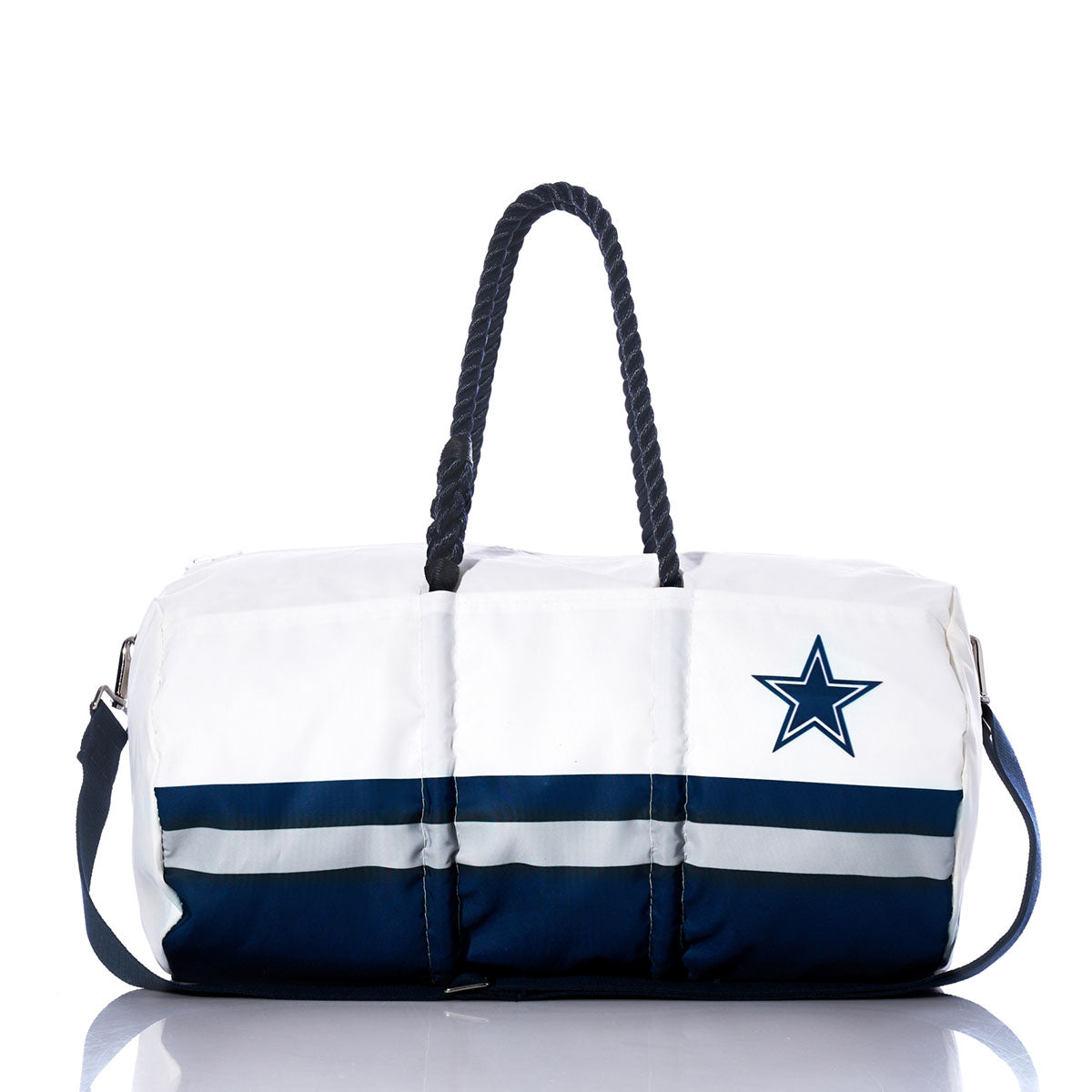 Sea Bags Dallas Cowboys Duffel featuring white and navy blue horizontal stripes, a rope handle, and a star logo on the side, crafted from recycled sail cloth and displayed on a reflective surface. by Sea Bags