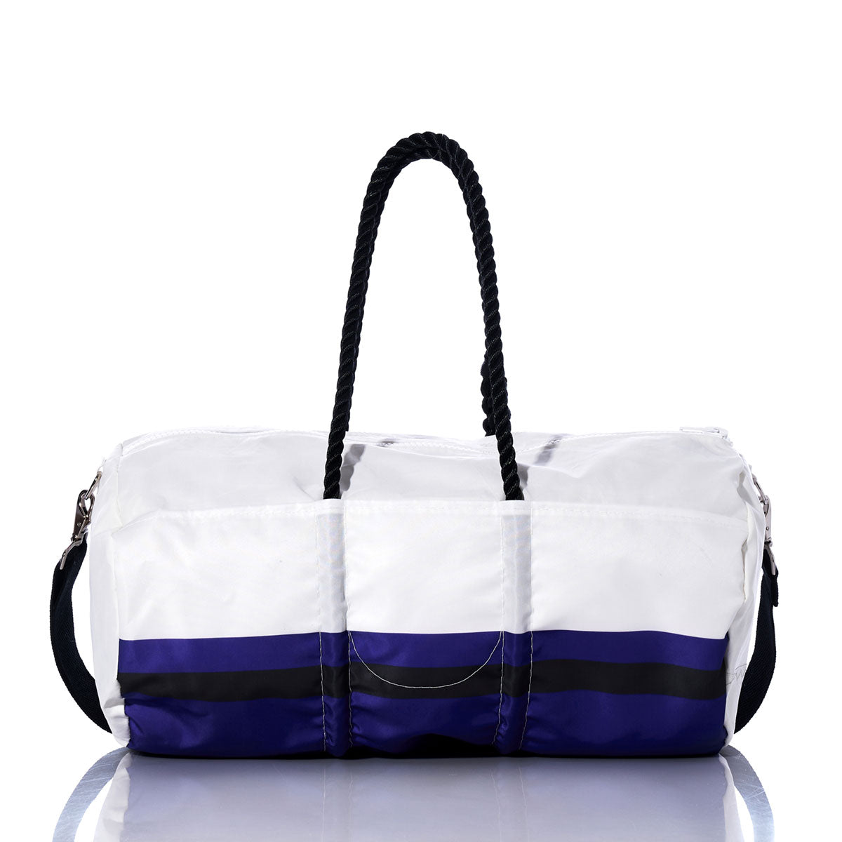 The Baltimore Ravens Duffel by Sea Bags, crafted from recycled sail cloth, features white and blue panels with black rope handles, a detachable shoulder strap, and horizontal color stripes near the base—shown here on a reflective surface. by Sea Bags