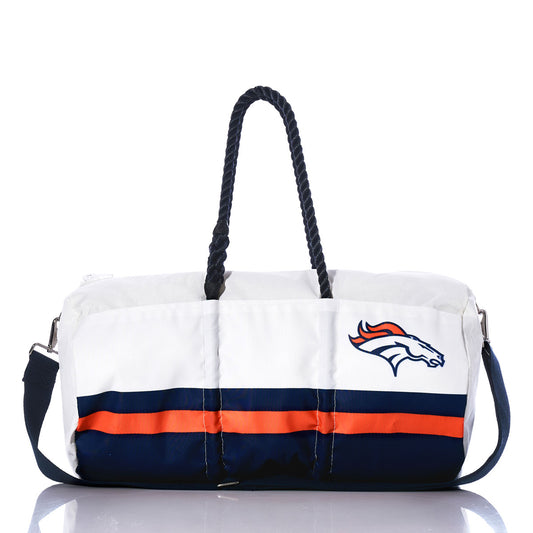 A Denver Broncos Duffel by Sea Bags, made from recycled sail cloth in white, navy, and orange with rope handles and a shoulder strap, is displayed centered against a white background. by Sea Bags