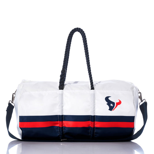 Experience the Houston Texans Duffel by Sea Bags—a durable NFL duffel crafted from recycled sail cloth, featuring blue and red stripes, black handles, and a bold sports team logo with a bull’s head and star. by Sea Bags