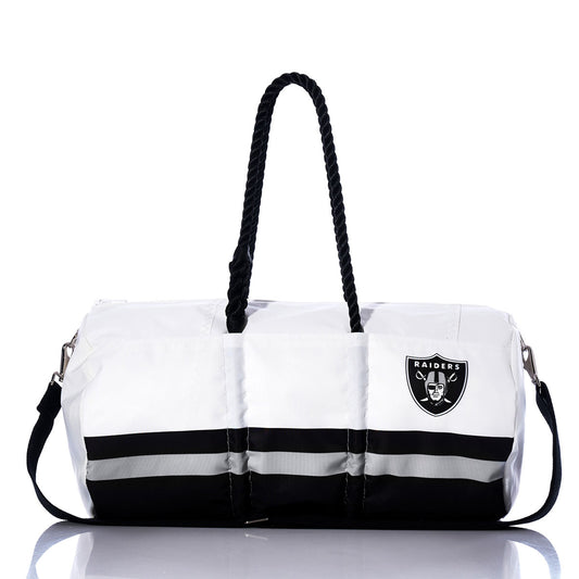 Show off your team spirit with the Las Vegas Raiders Duffel by Sea Bags—a white and black bag featuring sturdy black handles, a convenient shoulder strap, and the iconic Raiders logo on one side. Made from durable materials, this versatile Sea Bags duffel is ideal for travel or game days and perfect for any Las Vegas Raiders fan. by Sea Bags
