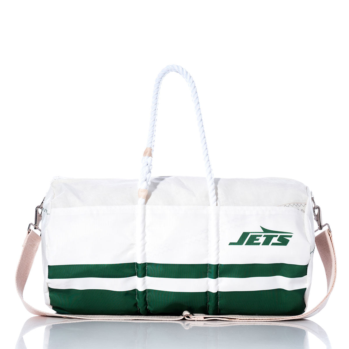 The Sea Bags New York Jets Duffel, crafted from recycled sail cloth and featuring the JETS logo, displays white and green panels with green stripes near the base, rope handles, a beige shoulder strap, and is shown on a reflective surface. by Sea Bags