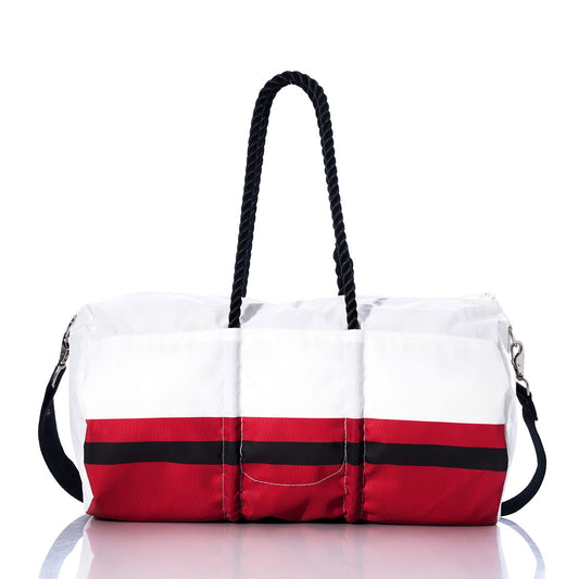 Introducing the Sea Bags Tampa Bay Buccaneers Duffel—a durable bag crafted from recycled sail cloth, featuring white and red panels, a black horizontal stripe, black rope handles, and an adjustable black shoulder strap. Shown on a reflective surface and officially licensed by the NFL, this duffel is perfect for any Tampa Bay fan. by Sea Bags