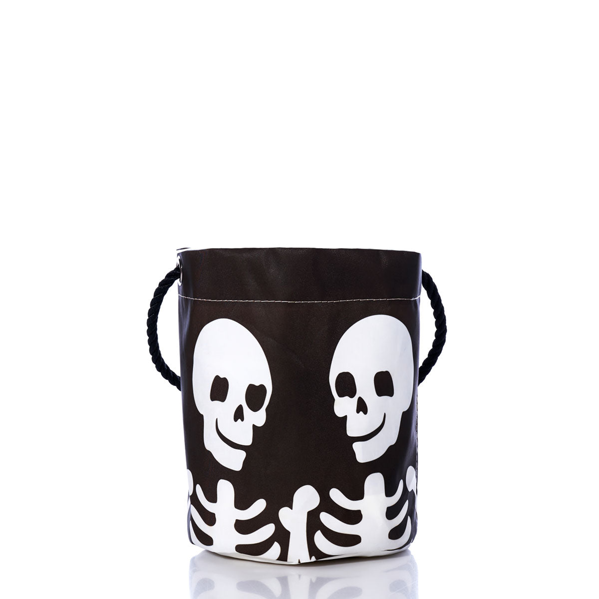 The Sea Bags Bucket of Bones Bag is a black bucket bag adorned with a white skeleton and skull design, featuring a sturdy black rope handle. Photographed against a white background, it’s the perfect eco-friendly choice for carrying Halloween candy or adding spooky flair to your celebrations.