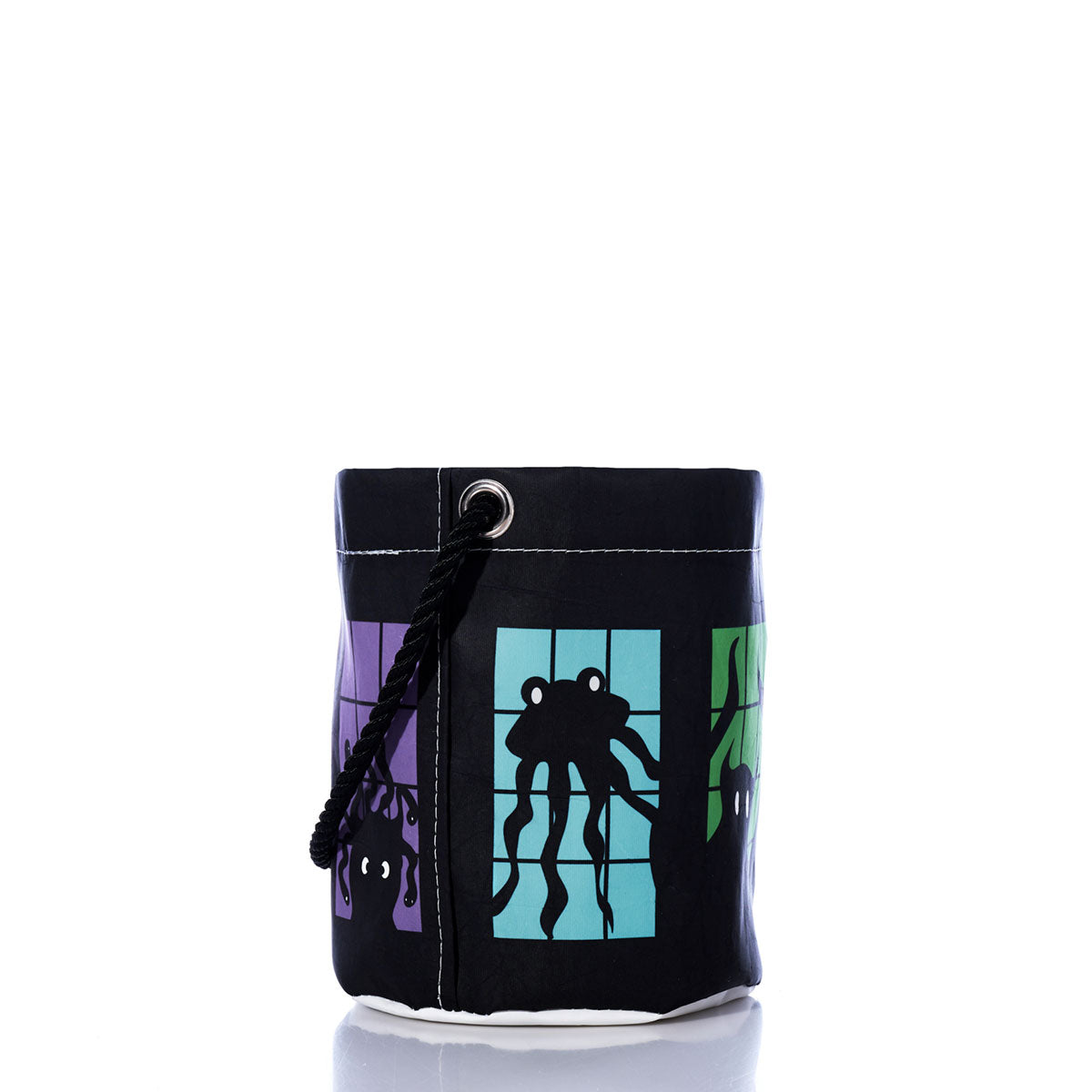 Introducing the Monster Party Bucket Bag from Sea Bags—a black cylindrical bucket bag crafted from recycled sails, featuring a rope handle. Showcasing vibrant square panels adorned with whimsical monster illustrations on a white background, this eco-friendly Halloween accessory brings playful charm to any celebration.