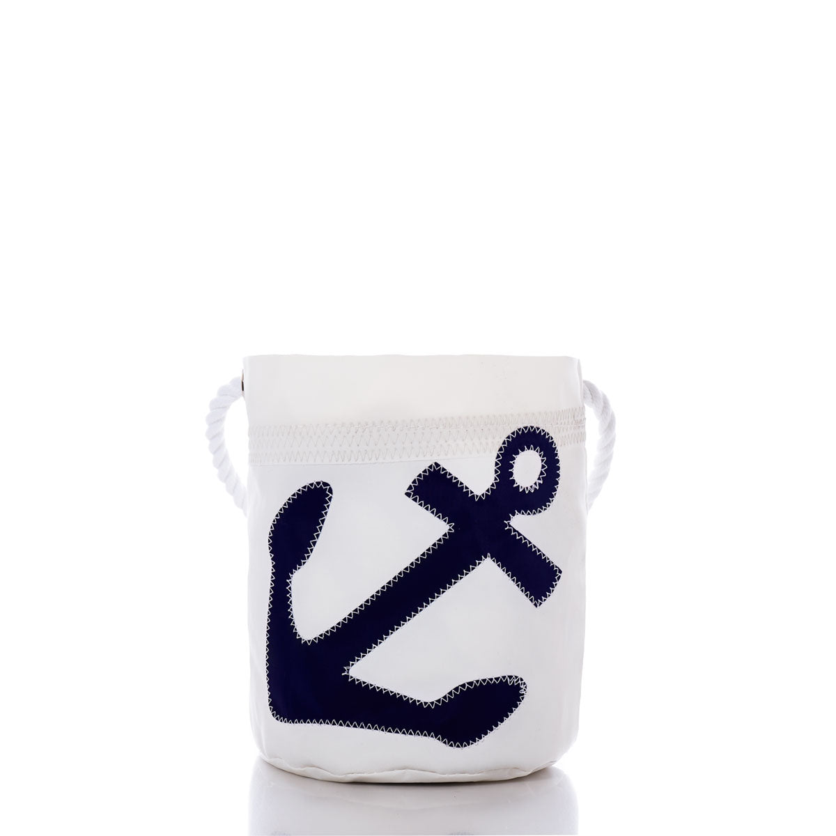 The Navy Anchor Bucket Bag by Sea Bags is a white, cylindrical canvas bucket bag made from recycled sail cloth, featuring thick rope handles and a prominent dark blue anchor appliqué on the front—an excellent example of sustainable style and versatility. by Sea Bags