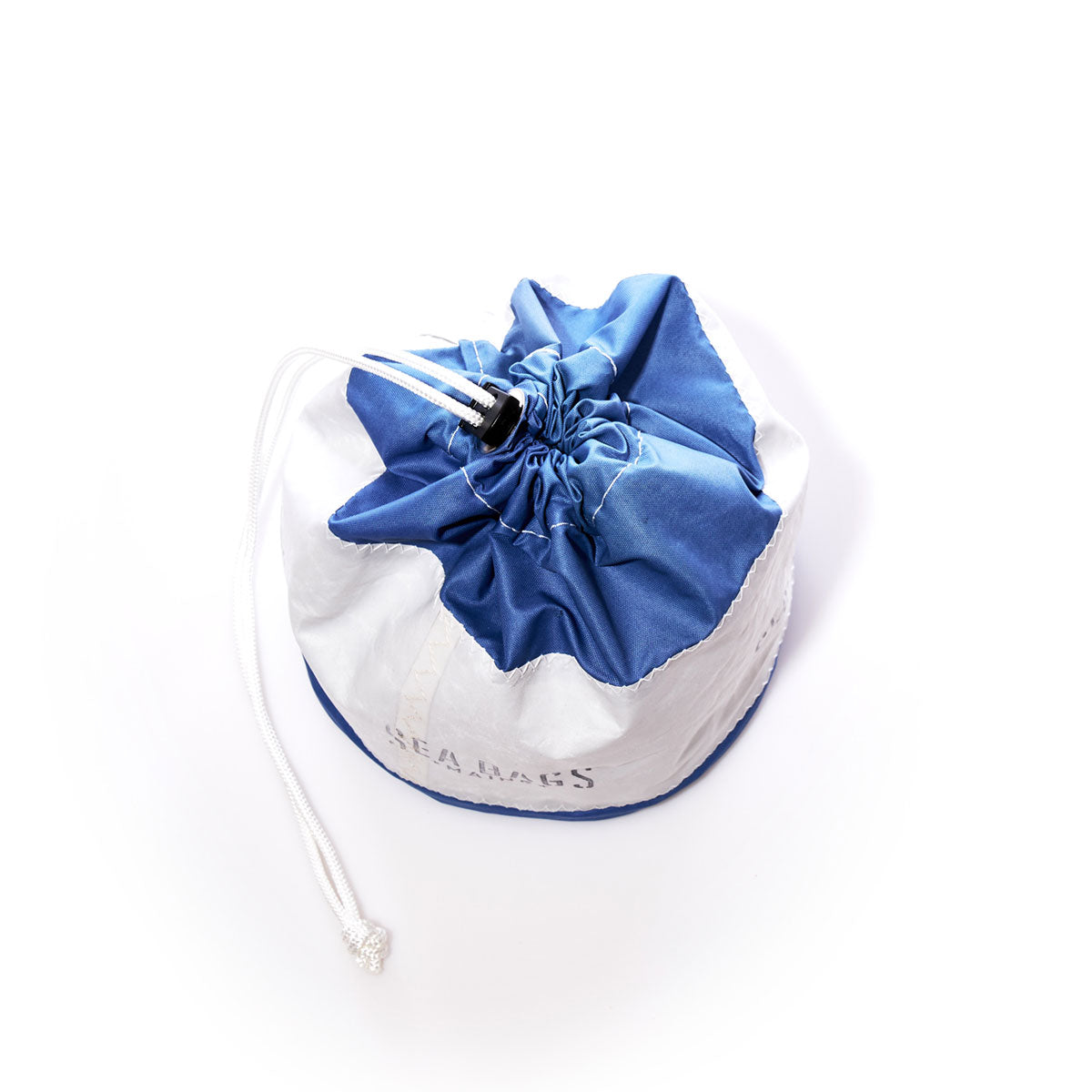The Sea Bags Ditty Bag, crafted from recycled sail bags in blue and white, features a cord lock closure at the top and is displayed on a white background. by Sea Bags