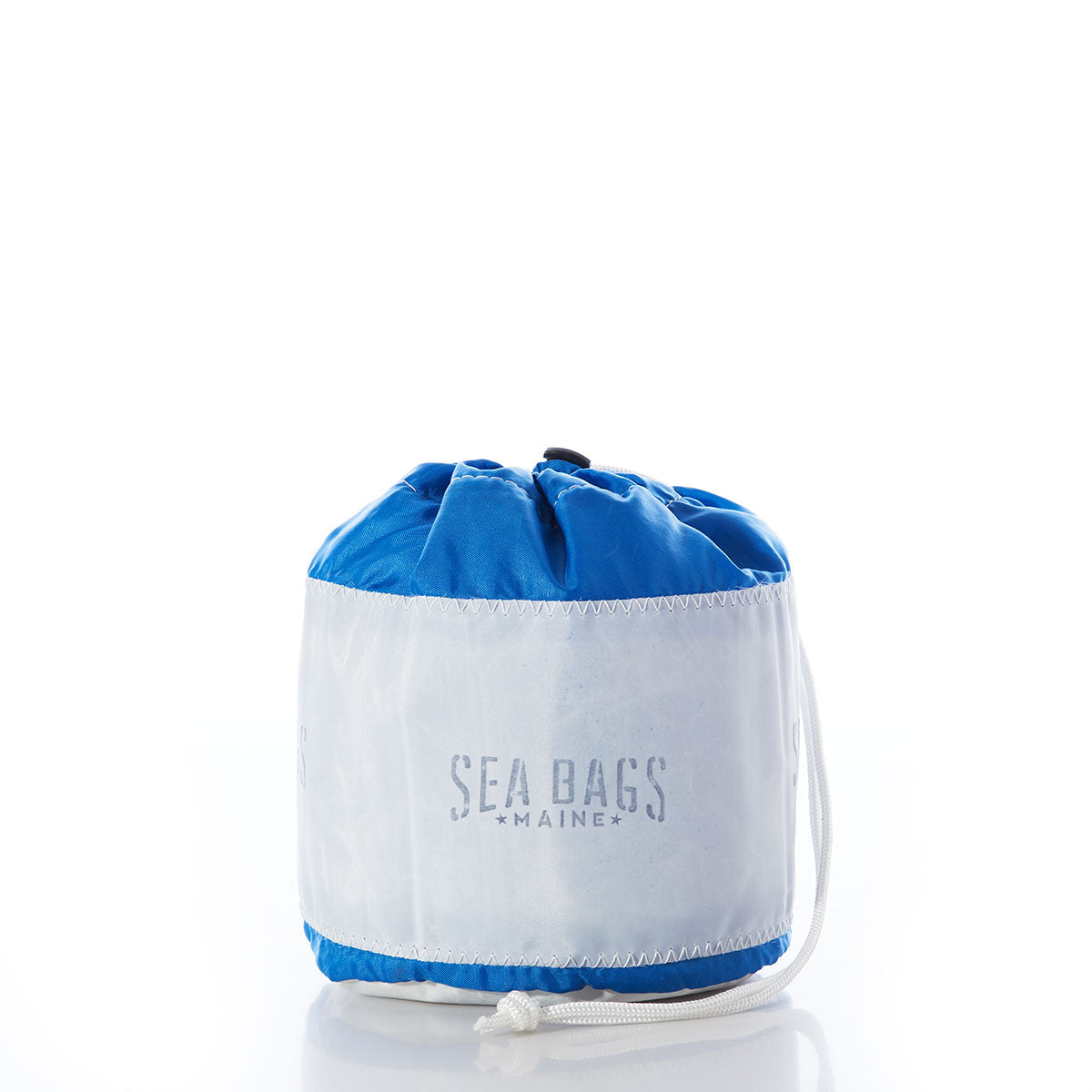 A white and blue Ditty Bag by Sea Bags, crafted from recycled sail bags, sits upright on a white background—perfect for stylish organization. by Sea Bags