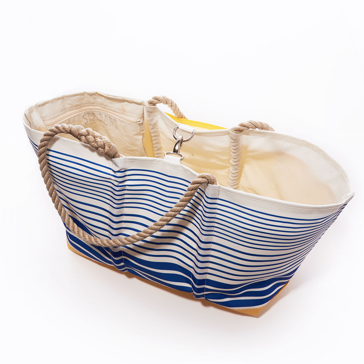 The Sea Bags Blue Stripe Ogunquit Beach Tote, crafted from recycled sail cloth with blue and white stripes, rope handles, and a beige interior, is displayed open against a white background. by Sea Bags
