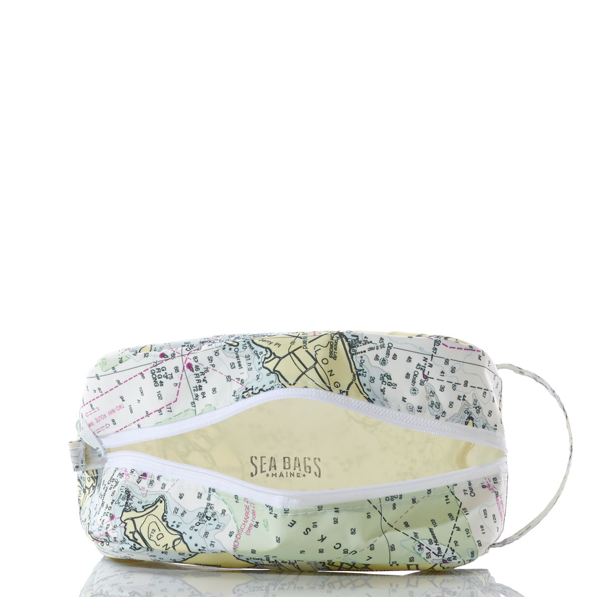 Casco Bay Nautical Chart Toiletry Bag by Sea Bags—a rectangular zippered pouch made from recycled sail cloth and adorned with a nautical chart design, shown partially open to display the Sea Bags Maine logo inside, all set against a white background. This stylish travel kit is ideal for organizing your essentials on your next adventure. by Sea Bags