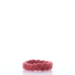 A red braided bracelet from Nantucket Knotworks, inspired by the classic Nantucket Rope Bracelet, is displayed on a white background. by Sea Bags