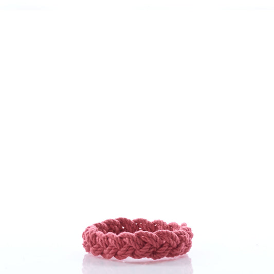 A red braided bracelet from Nantucket Knotworks, inspired by the classic Nantucket Rope Bracelet, is displayed on a white background. by Sea Bags