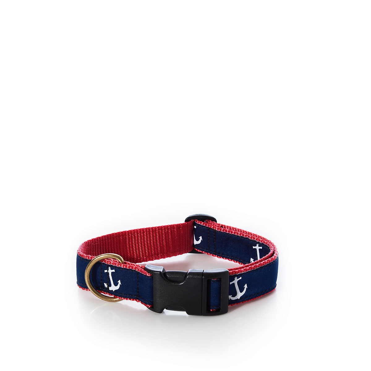 The Belted Cow Dog Collar - Anchors by Belted Cow is crafted in the USA from durable nylon webbing, featuring navy blue and red colors with white anchor designs, a black plastic buckle, and a gold metal ring. It is displayed on a white background. by Sea Bags