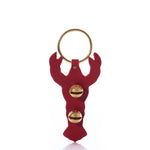 New England Bells’ Red Lobster Door Chime features a red, handcrafted leather lobster adorned with two small gold seashells.