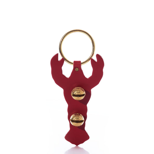 New England Bells’ Red Lobster Door Chime features a red, handcrafted leather lobster adorned with two small gold seashells.