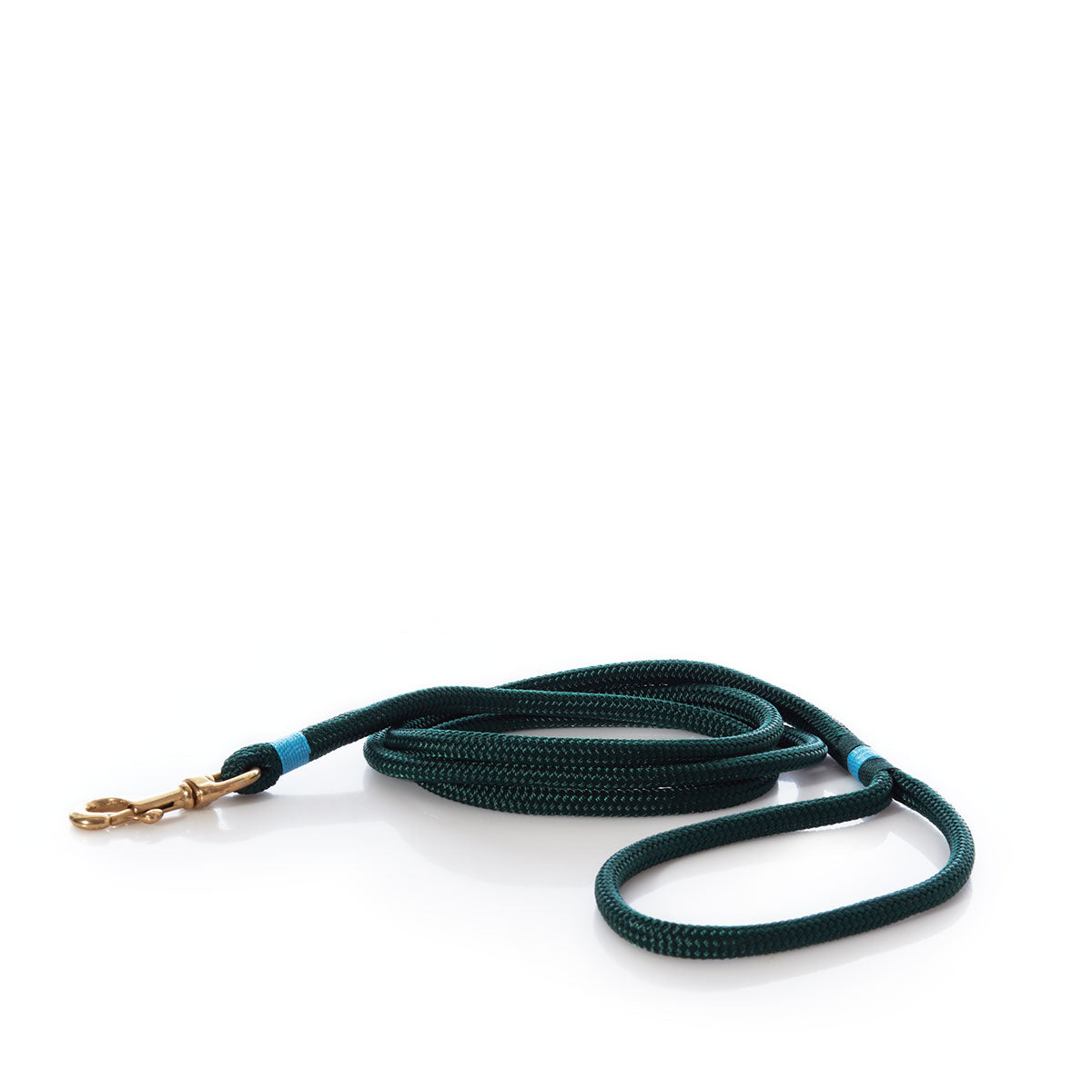 A Maine Rope Dog Leash - Hunter Green by Custom Cordage / DBA Maine Rope Mats, featuring a rich dark green yacht braid and a sturdy brass clasp, is coiled neatly on a white background. This nautical dog leash blends durability with timeless style—ideal for daily adventures. by Sea Bags