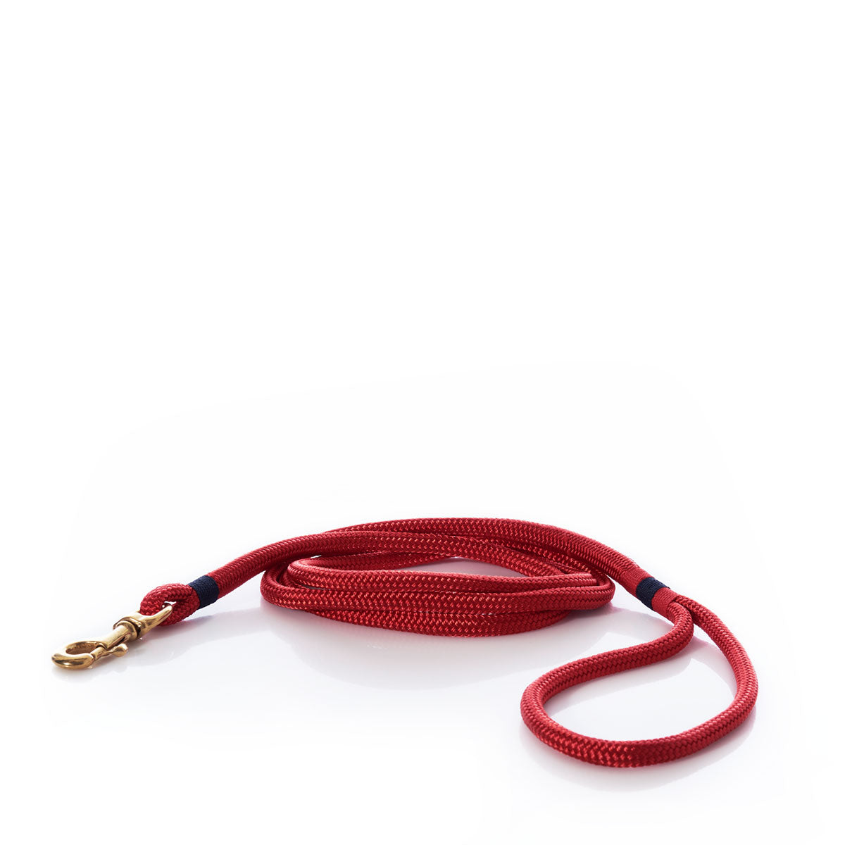 A Maine Rope Dog Leash in Deep Red by Custom Cordage / DBA Maine Rope Mats, featuring a coiled handmade design with a brass clip, displayed on a white background. by Sea Bags